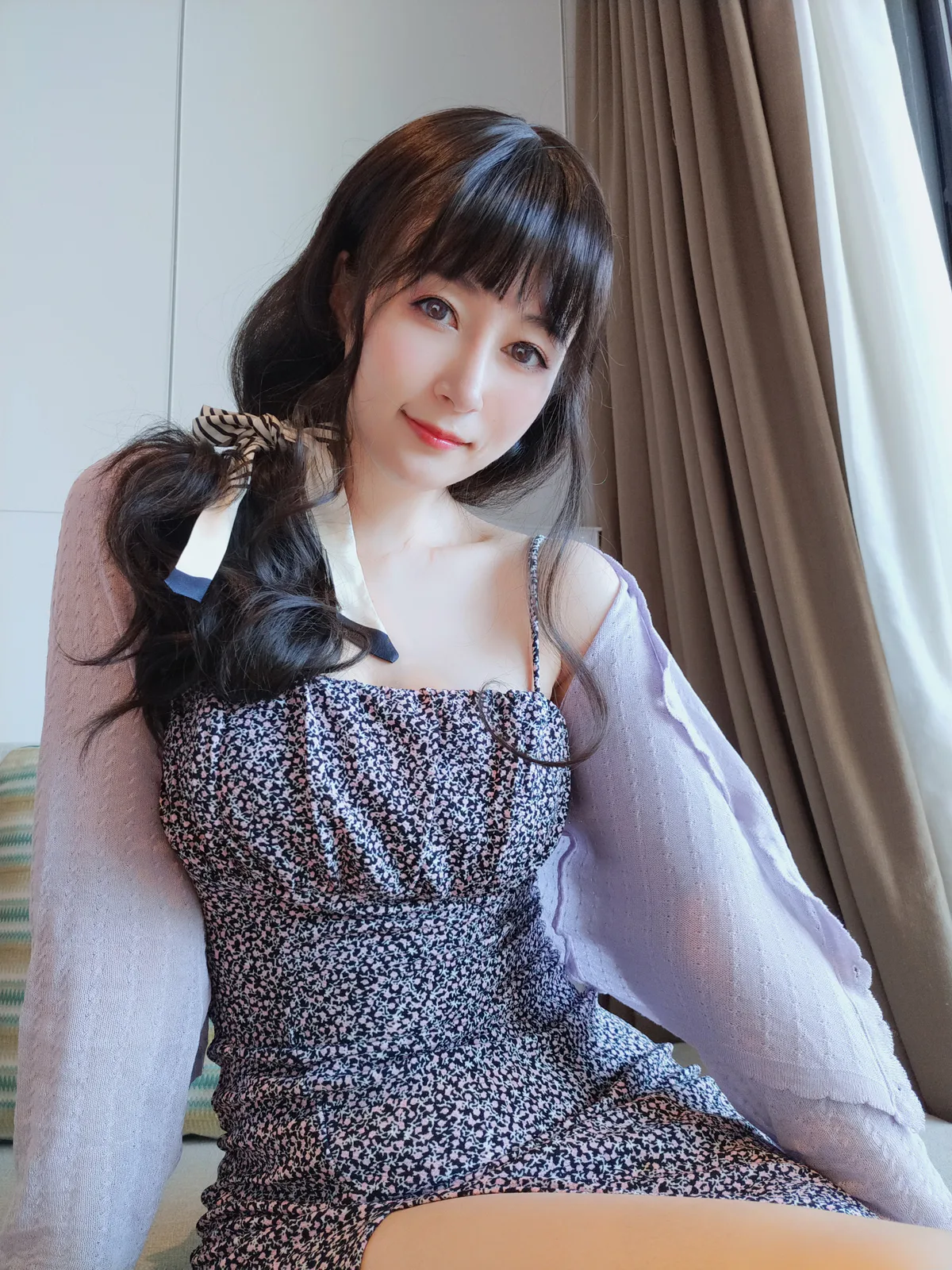 白银81，长发人物穿碎花裙在沙发旁侧坐